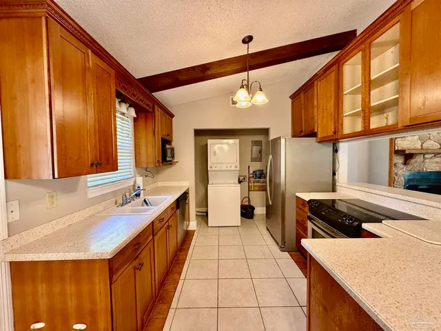 a kitchen with stainless steel appliances granite countertop a sink and cabinets