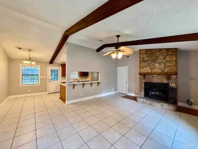 a large kitchen with a stove and a fireplace