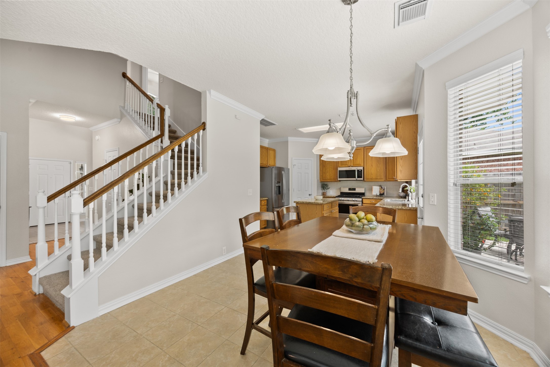 2219 Louetta Brook Lane Spring, TX 77388 - Photo 12 of 34 Dining area seamlessly connected to the kitchen, offering easy flow and a view into the living spaces and staircase.