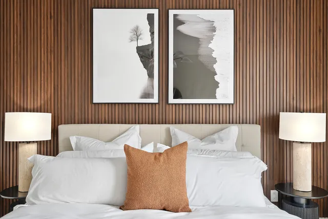 a bedroom with a bed and a night stand