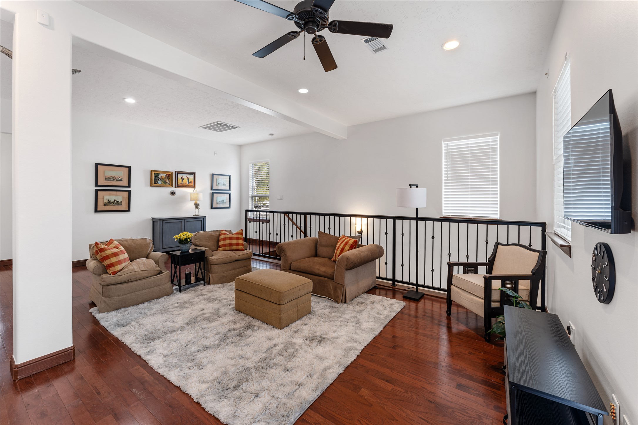 415 West 8th Street Houston, TX 77007 - Photo 24 of 39 The generous living room offers plenty of space for relaxing or entertaining while maintaining an open connection to the kitchen. Hardwood floors, recessed lighting, ceiling fans, and large windows create a bright, comfortable environment that feels both spacious and welcoming.