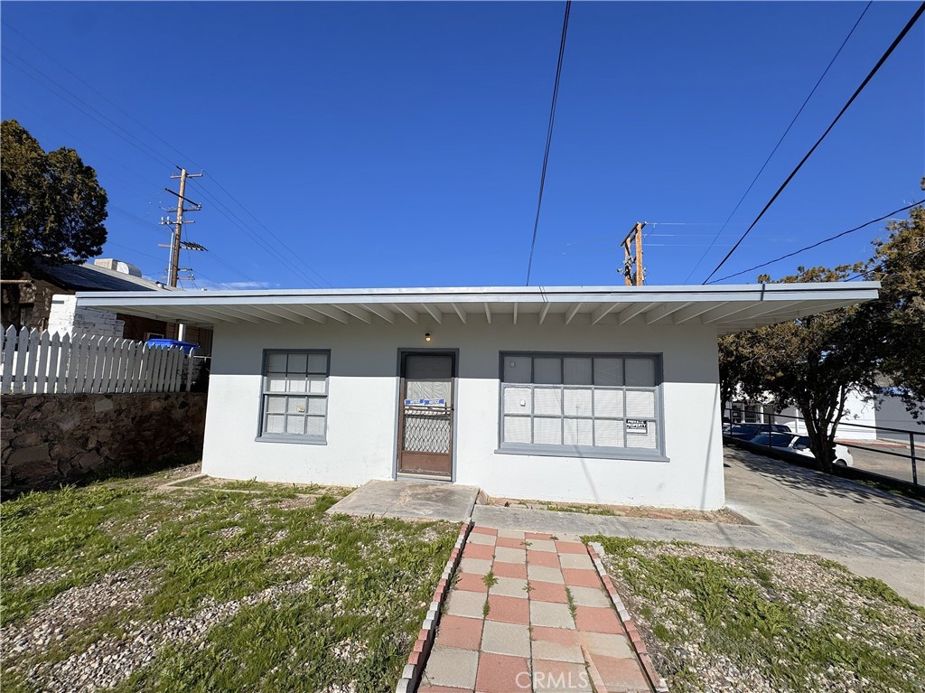 521 East Williams Street Barstow, CA 92311 - Photo 11 of 26 a front view of a house with a yard and garage