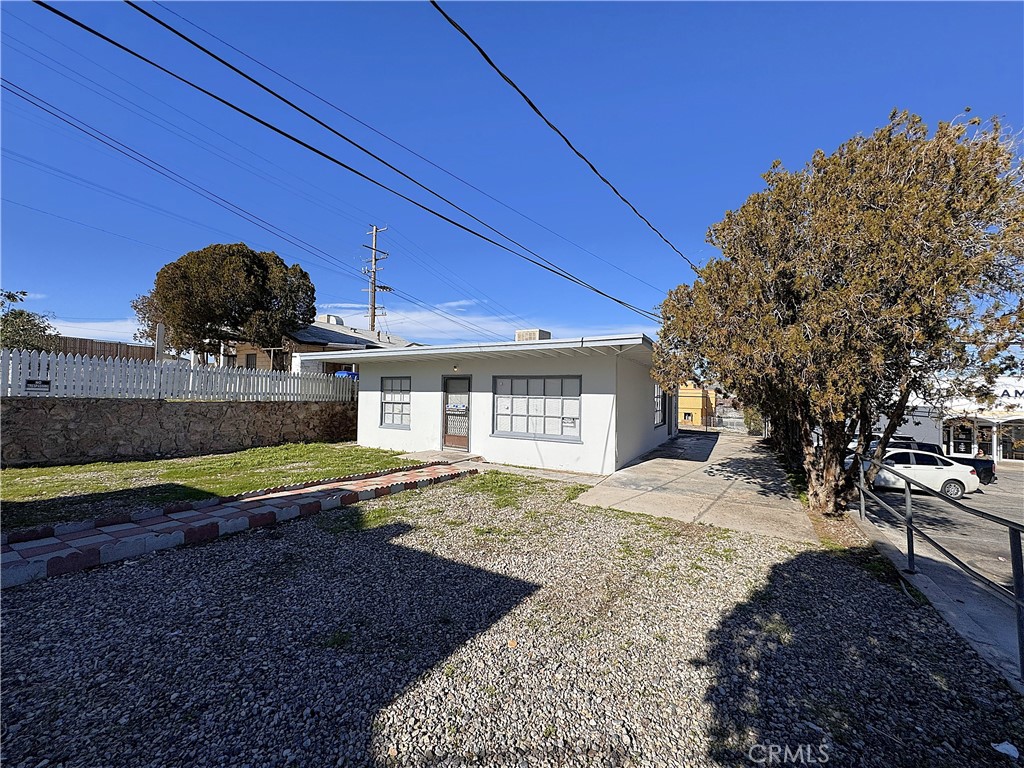 521 East Williams Street Barstow, CA 92311 - Photo 13 of 26 a view of a house with a yard