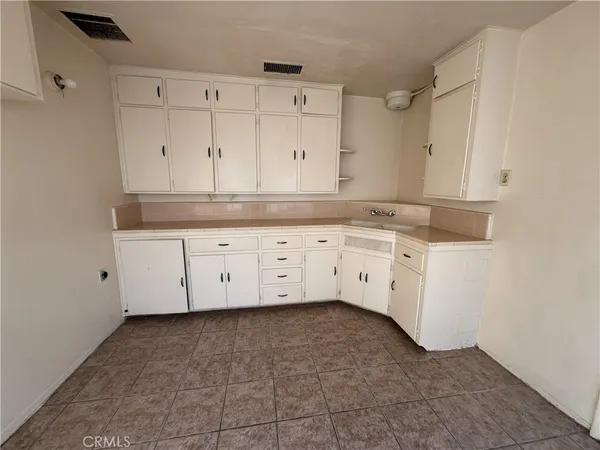 a view of cabinets with granite countertop white cabinets