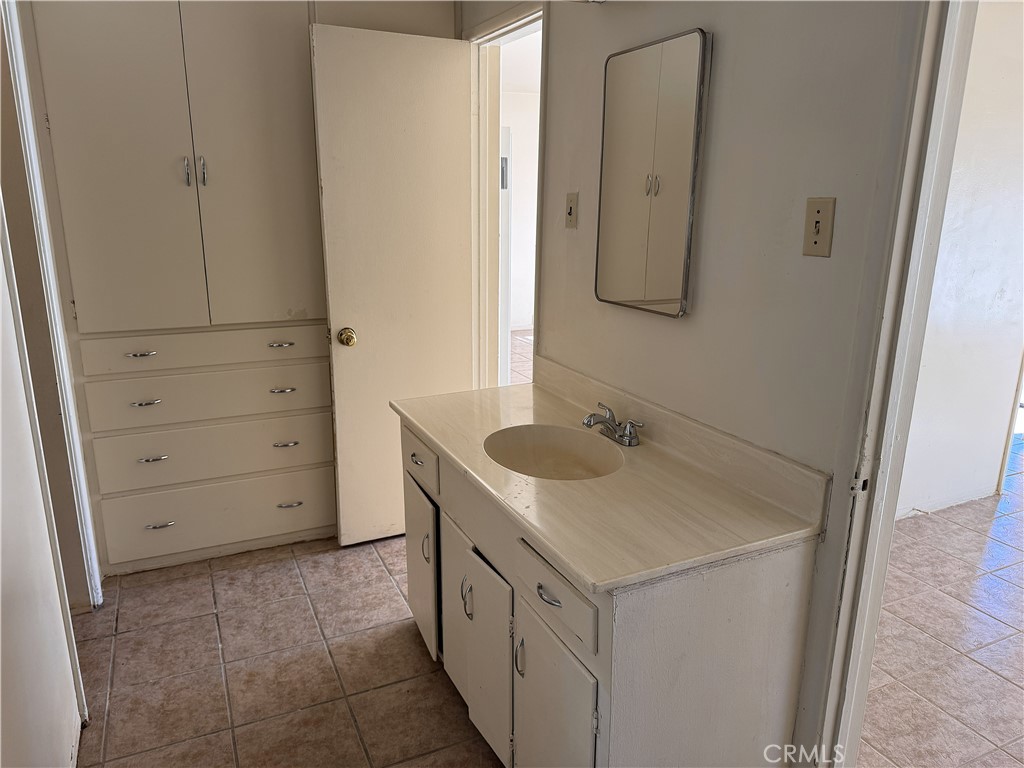 521 East Williams Street Barstow, CA 92311 - Photo 22 of 26 a bathroom with a sink and a mirror