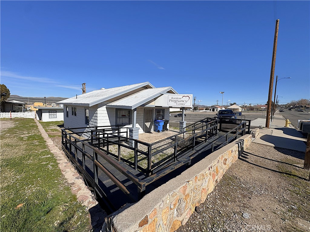 521 East Williams Street Barstow, CA 92311 - Photo 5 of 26 a roof deck with table and chairs a barbeque
