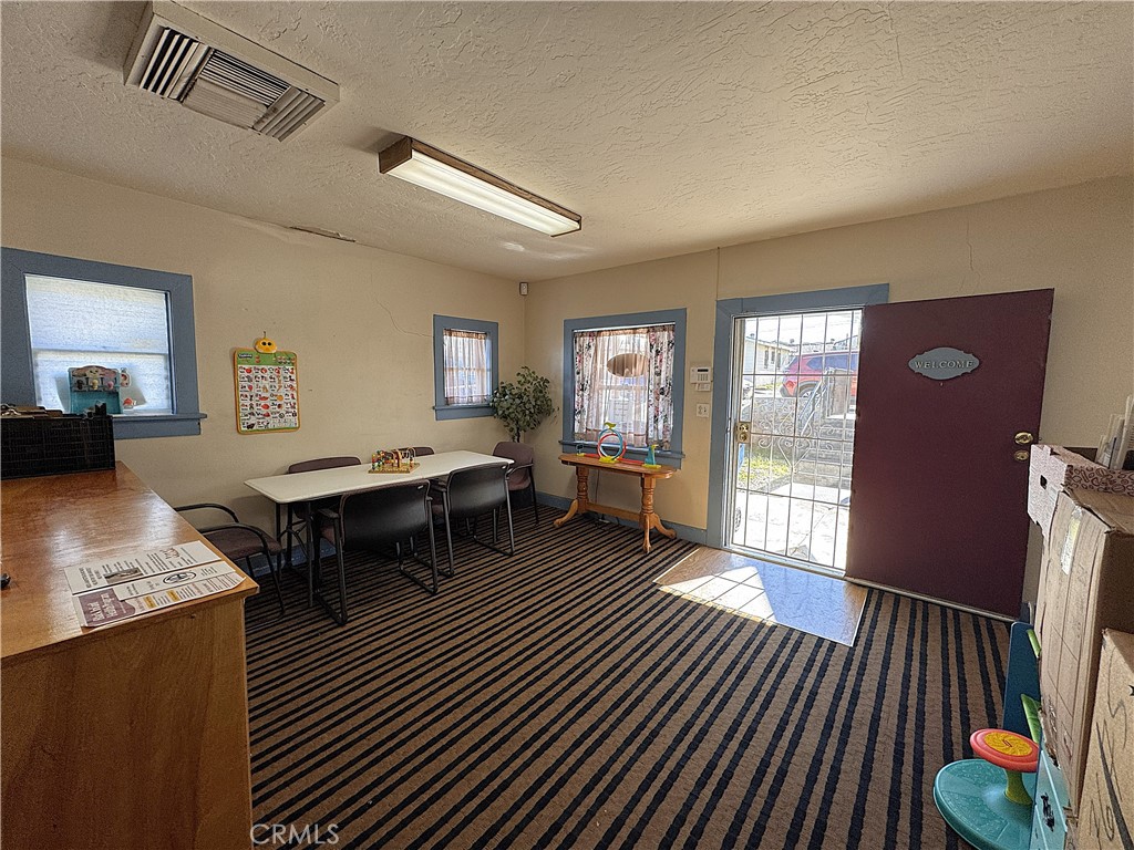 521 East Williams Street Barstow, CA 92311 - Photo 6 of 26 a living room with furniture a rug and a floor to ceiling window