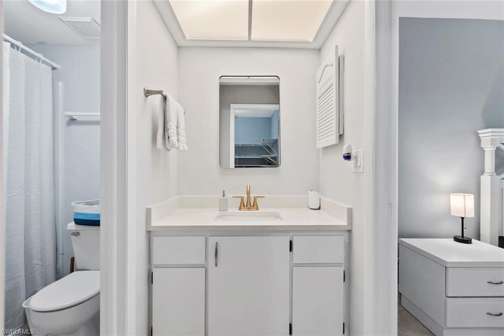 3410 Frosty Way, Unit 4802 Naples, FL 34112 - Photo 12 of 27 Full bathroom with vanity, toilet, and a shower with curtain