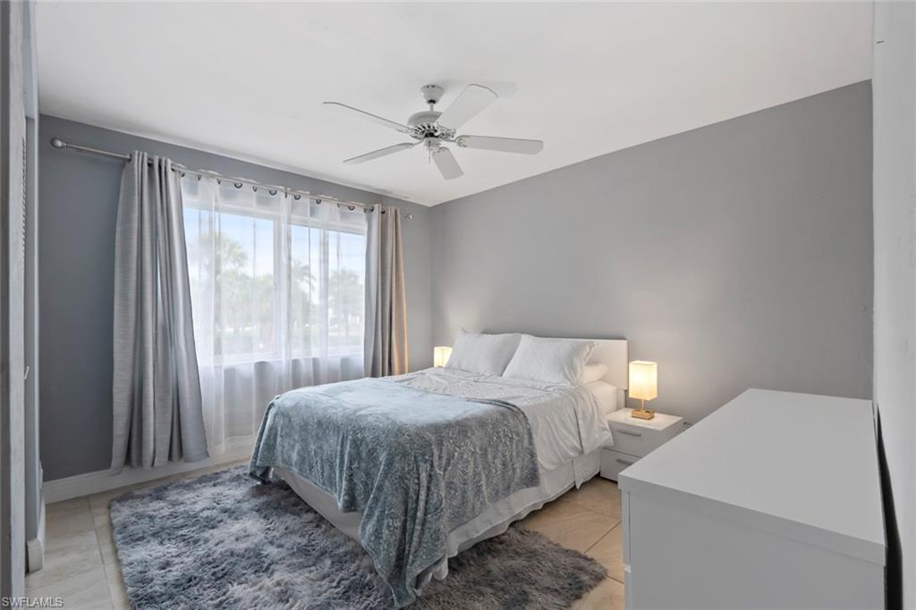 3410 Frosty Way, Unit 4802 Naples, FL 34112 - Photo 13 of 27 Bedroom featuring ceiling fan, light tile patterned floors, and baseboards