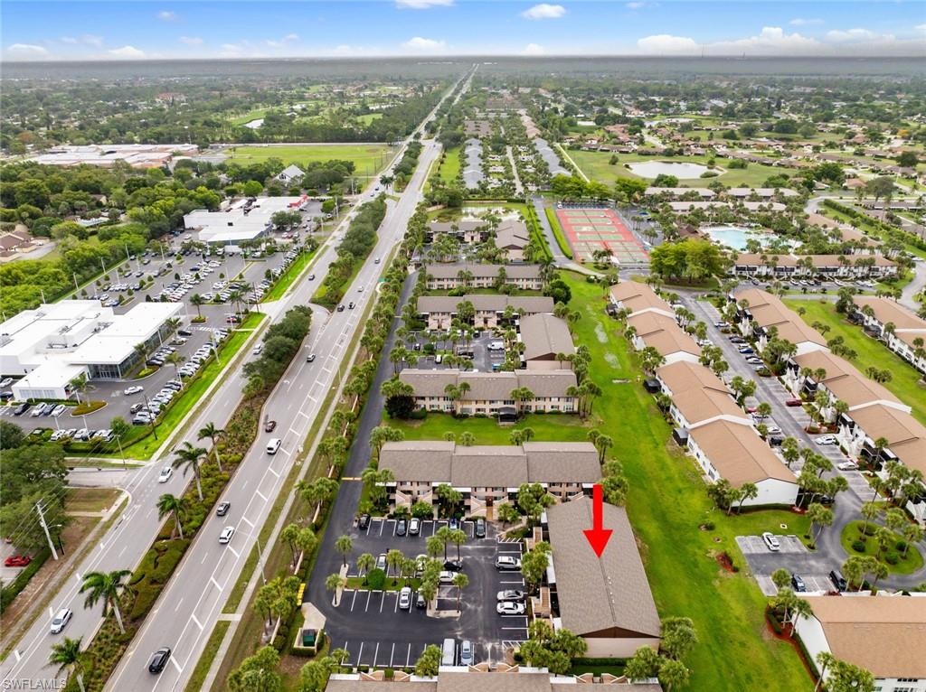 3410 Frosty Way, Unit 4802 Naples, FL 34112 - Photo 20 of 27 Aerial view of residential area with a major roadway and a nearby body of water