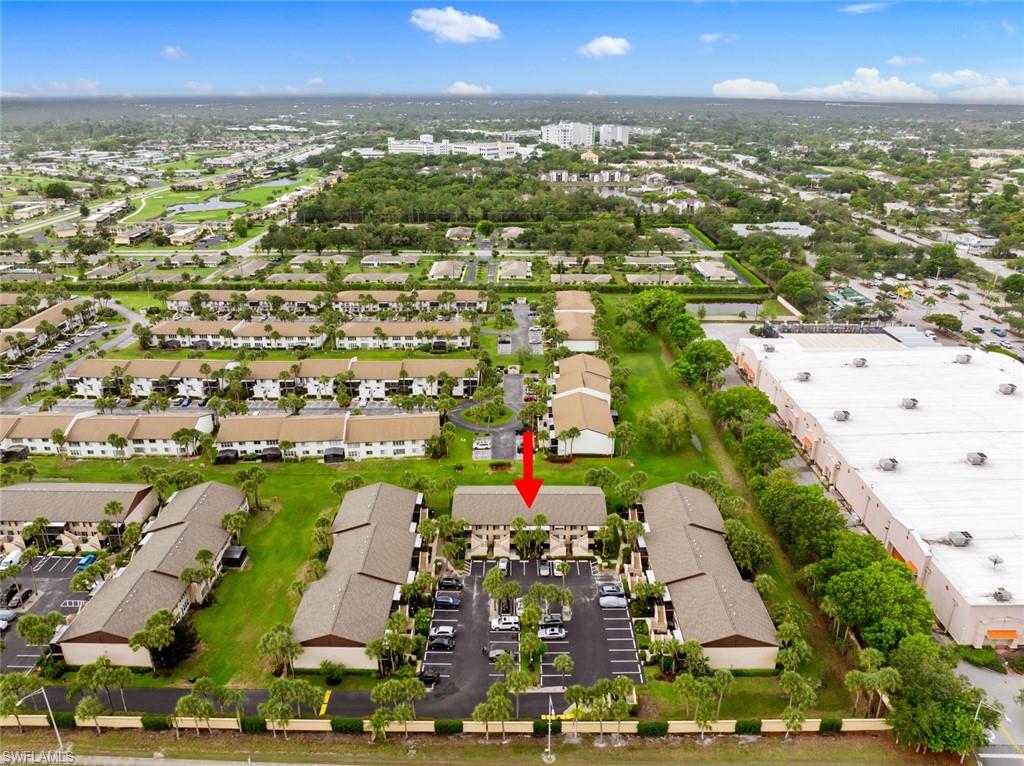 3410 Frosty Way, Unit 4802 Naples, FL 34112 - Photo 23 of 27 Aerial view of property and surrounding area with nearby suburban area