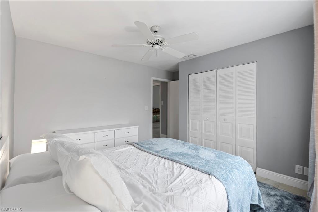 3410 Frosty Way, Unit 4802 Naples, FL 34112 - Photo 24 of 27 Bedroom featuring a closet, baseboards, and ceiling fan