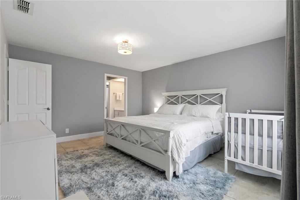 3410 Frosty Way, Unit 4802 Naples, FL 34112 - Photo 10 of 27 Bedroom featuring light tile patterned floors and baseboards