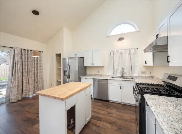 a kitchen with a sink stove and refrigerator