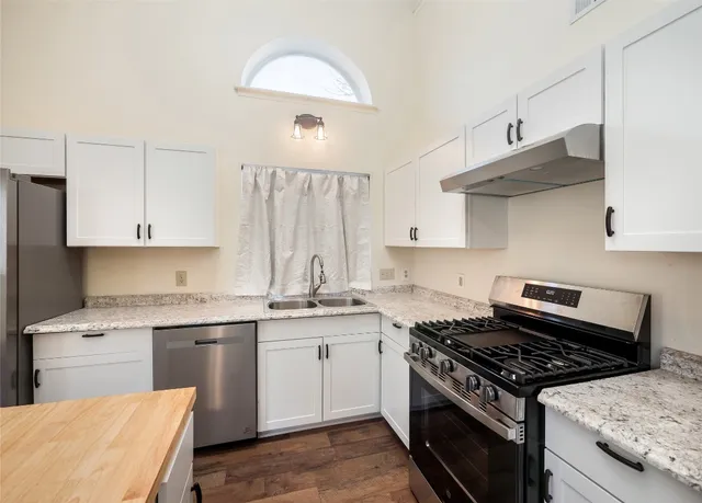 a kitchen with a stove and a sink