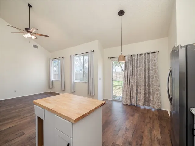 a kitchen with kitchen island white cabinets and wooden floor