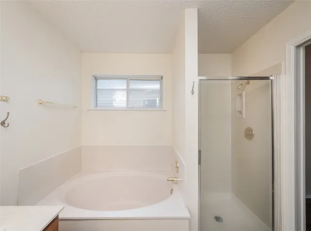 a white bath tub sitting next to a white sink