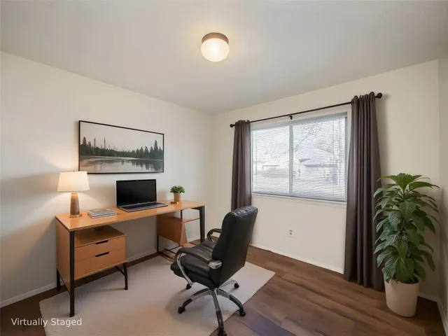 a view of a workspace with furniture and a potted plant