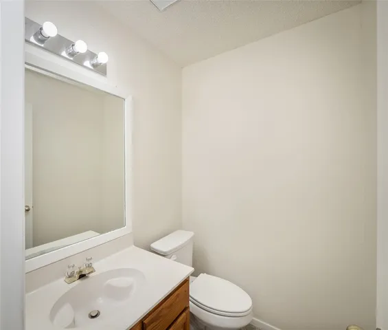 a bathroom with a sink a toilet and mirror