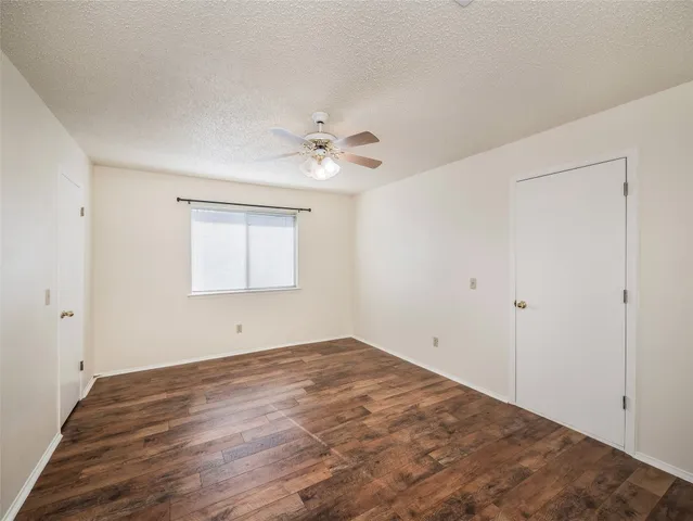 a view of an empty room with a ceiling fan