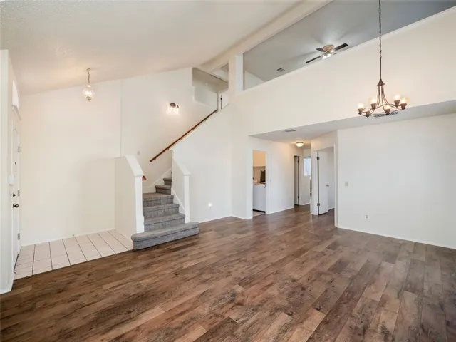 a view of a livingroom with wooden floor and stairs