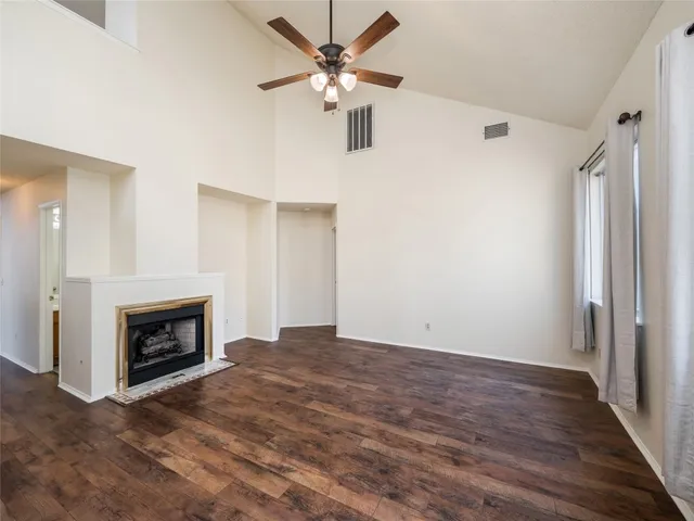 a view of an empty room with a fireplace