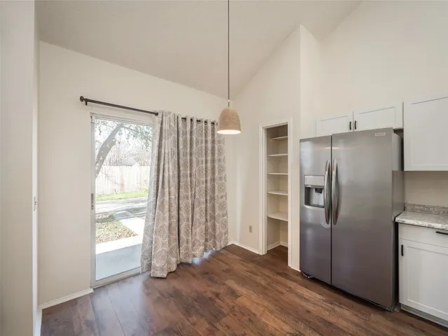a kitchen with stainless steel appliances a refrigerator and wooden floor