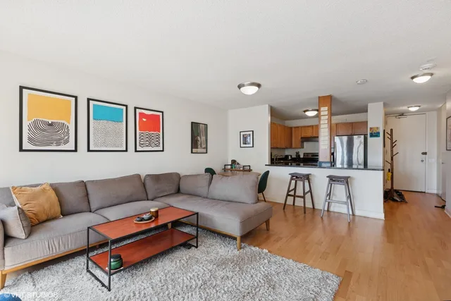 a living room with furniture and kitchen view