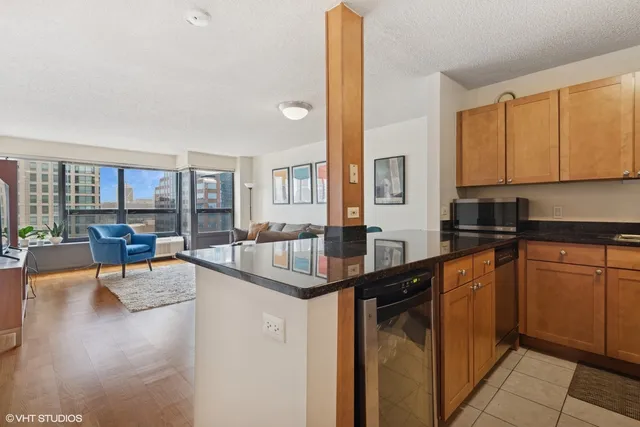a kitchen with granite countertop a sink and cabinets