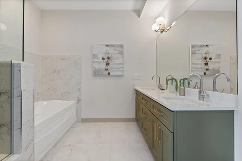 a bathroom with a granite countertop sink a bathtub and shower