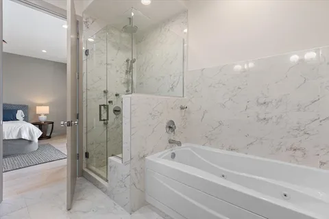 a spacious bathroom with a bathtub and a shower