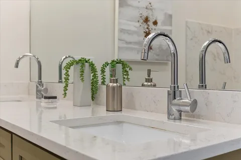 a bathroom with a double vanity sink