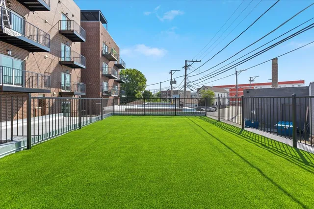 a view of a backyard with a garden and deck