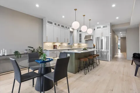 a large kitchen with a table and chairs