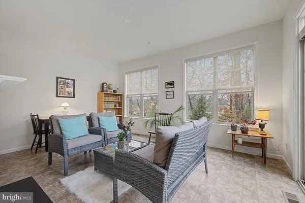 a living room with furniture and a floor to ceiling window