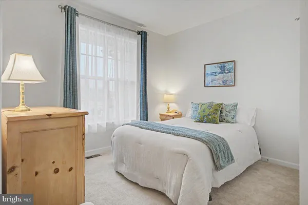 a bedroom with a bed and a lamp