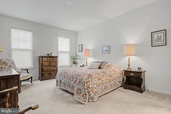 a bedroom with a bed and a lamp