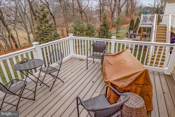 a view of a chair and table on the deck