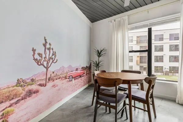 a view of a dining room with furniture and window