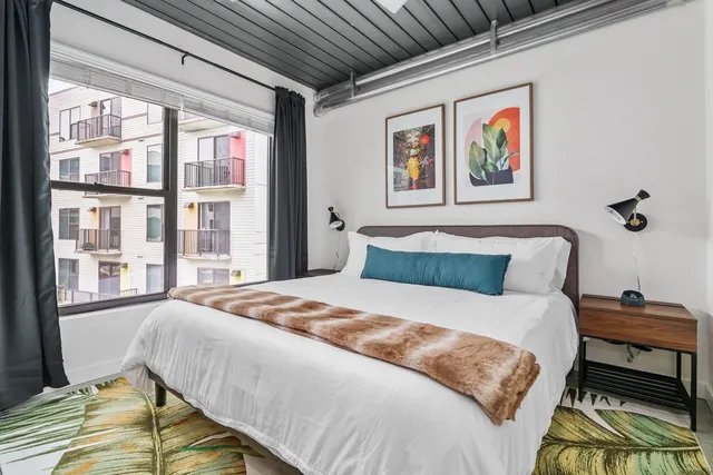 a bedroom with a bed and a window