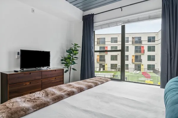 a bedroom with a bed and a flat screen tv
