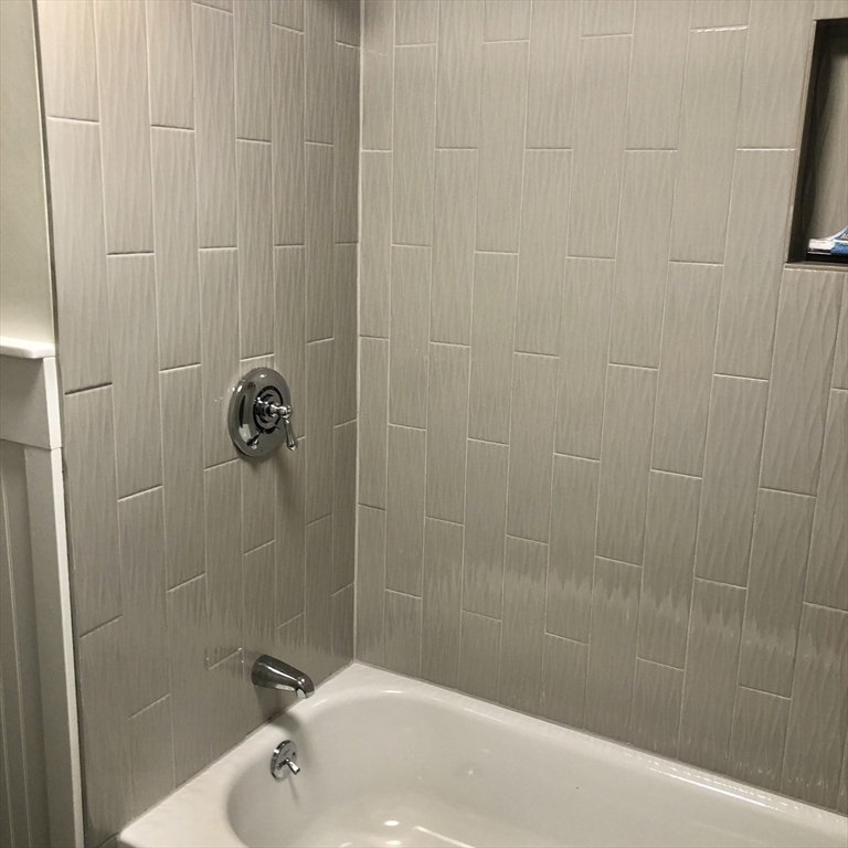 46 Legate Hill Road Leominster, MA 01453 - Photo 16 of 20 a bath tub sitting next to a white sink and a shower