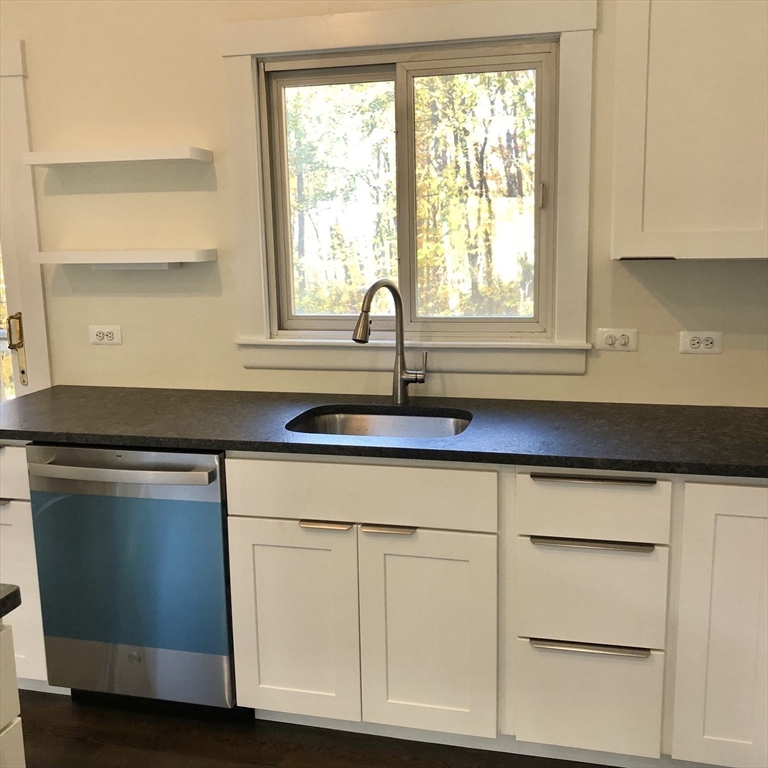 46 Legate Hill Road Leominster, MA 01453 - Photo 7 of 20 a kitchen with white cabinets and a window