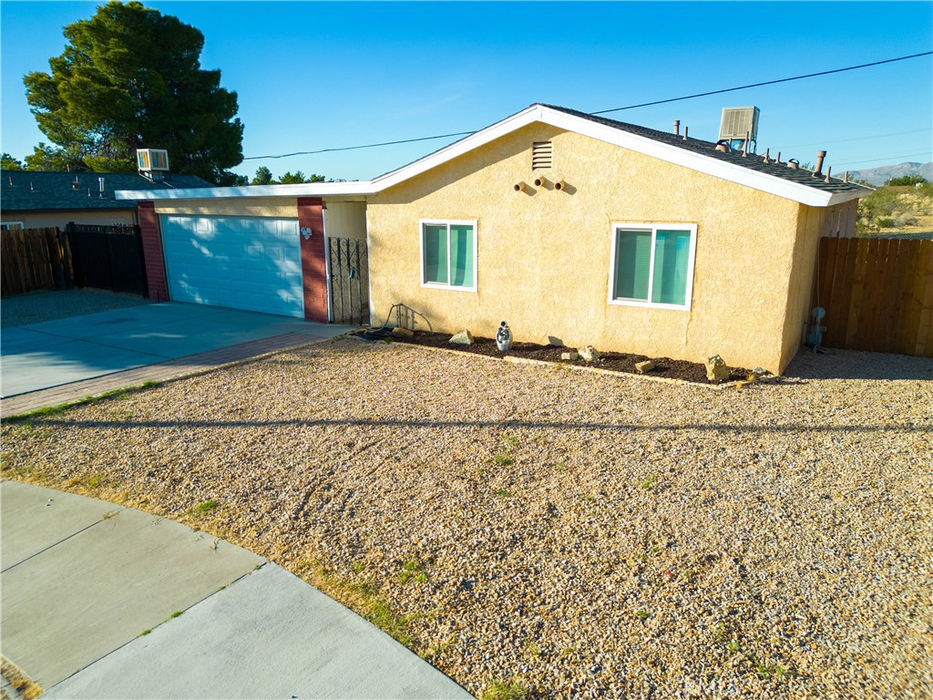16612 Lariat Road Victorville, CA 92395 - Photo 1 of 1 a front view of a house with a yard