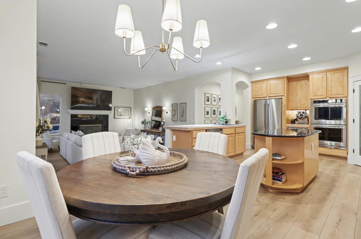 3835 Deer Ridge Lane Auburn, CA 95602 - Photo 24 of 79 a view of a dining room with furniture a chandelier and kitchen view