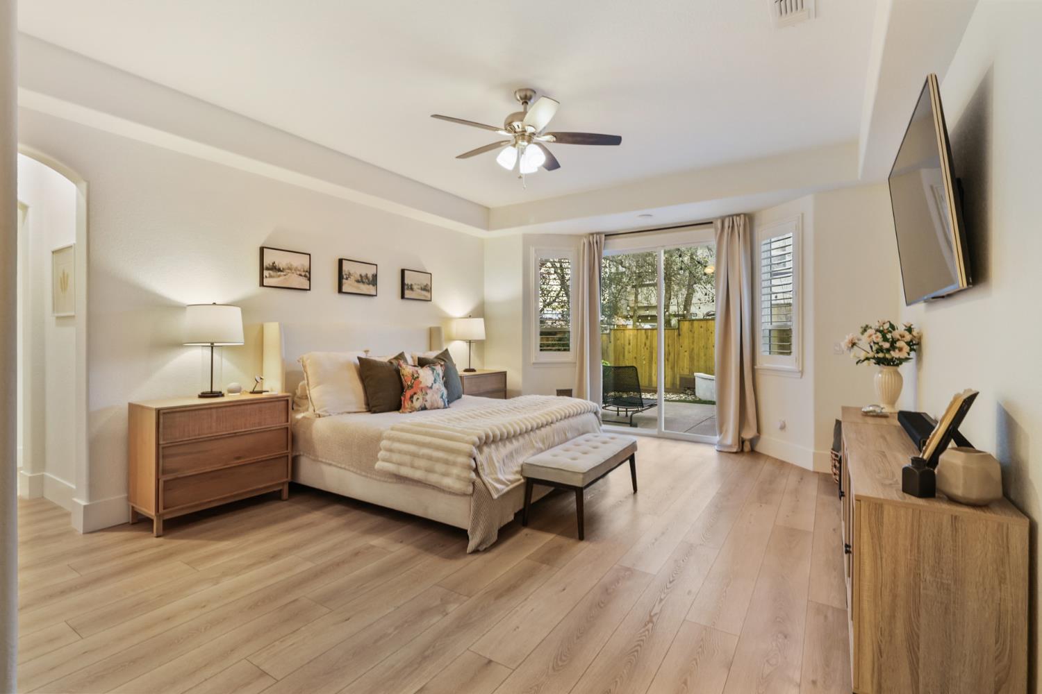 3835 Deer Ridge Lane Auburn, CA 95602 - Photo 32 of 79 a spacious bedroom with a bed and a flat tv screen on dresser