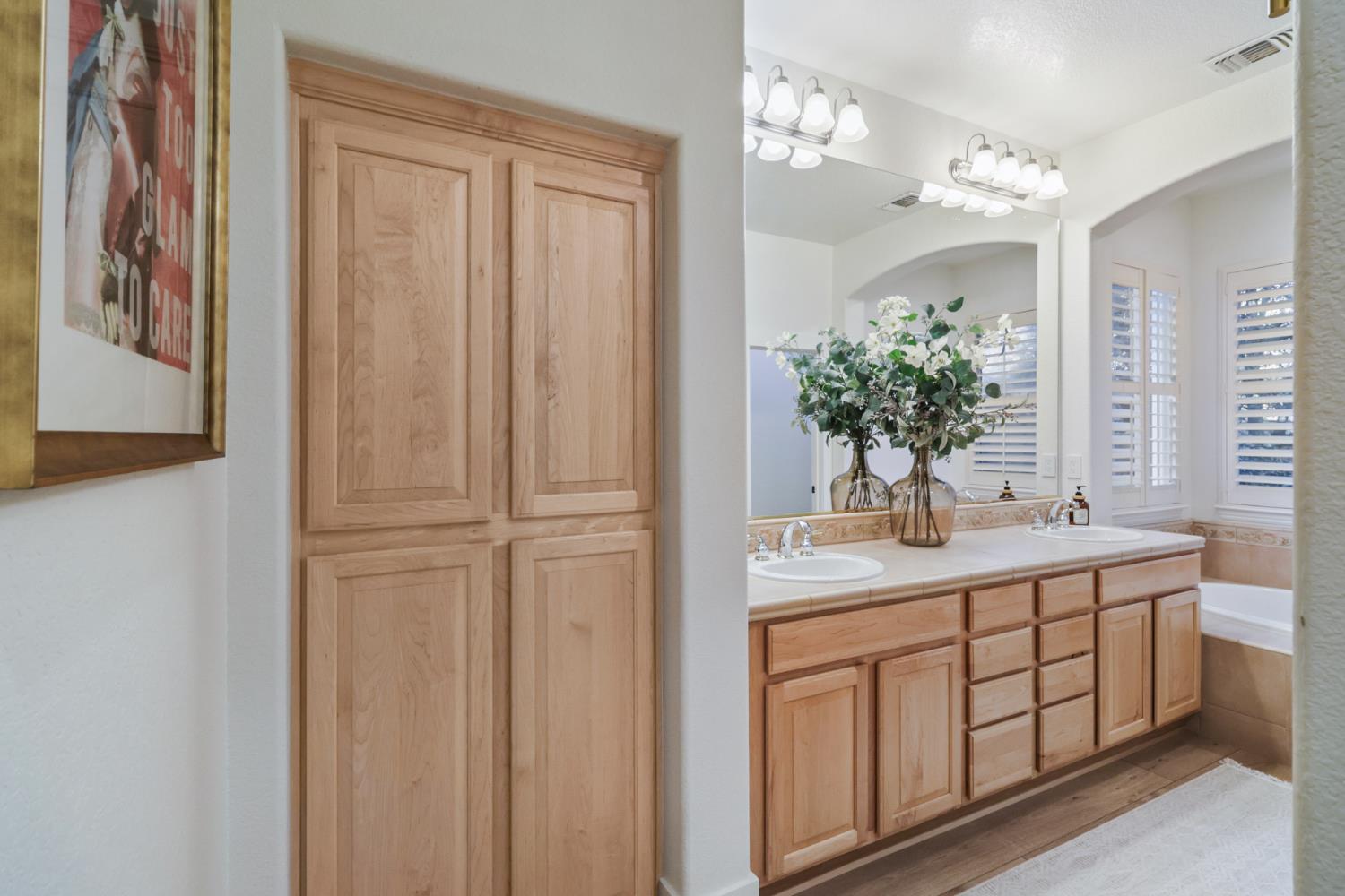 3835 Deer Ridge Lane Auburn, CA 95602 - Photo 34 of 79 a bathroom with a double vanity sink and a mirror
