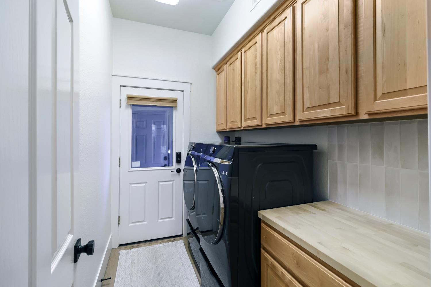 3835 Deer Ridge Lane Auburn, CA 95602 - Photo 42 of 79 a utility room with granite countertop a sink a washer and dryer