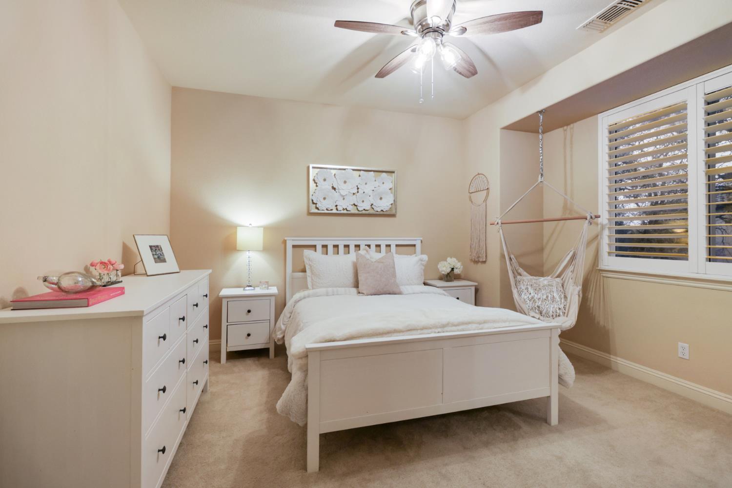 3835 Deer Ridge Lane Auburn, CA 95602 - Photo 50 of 79 a bedroom with a bed and a chandelier