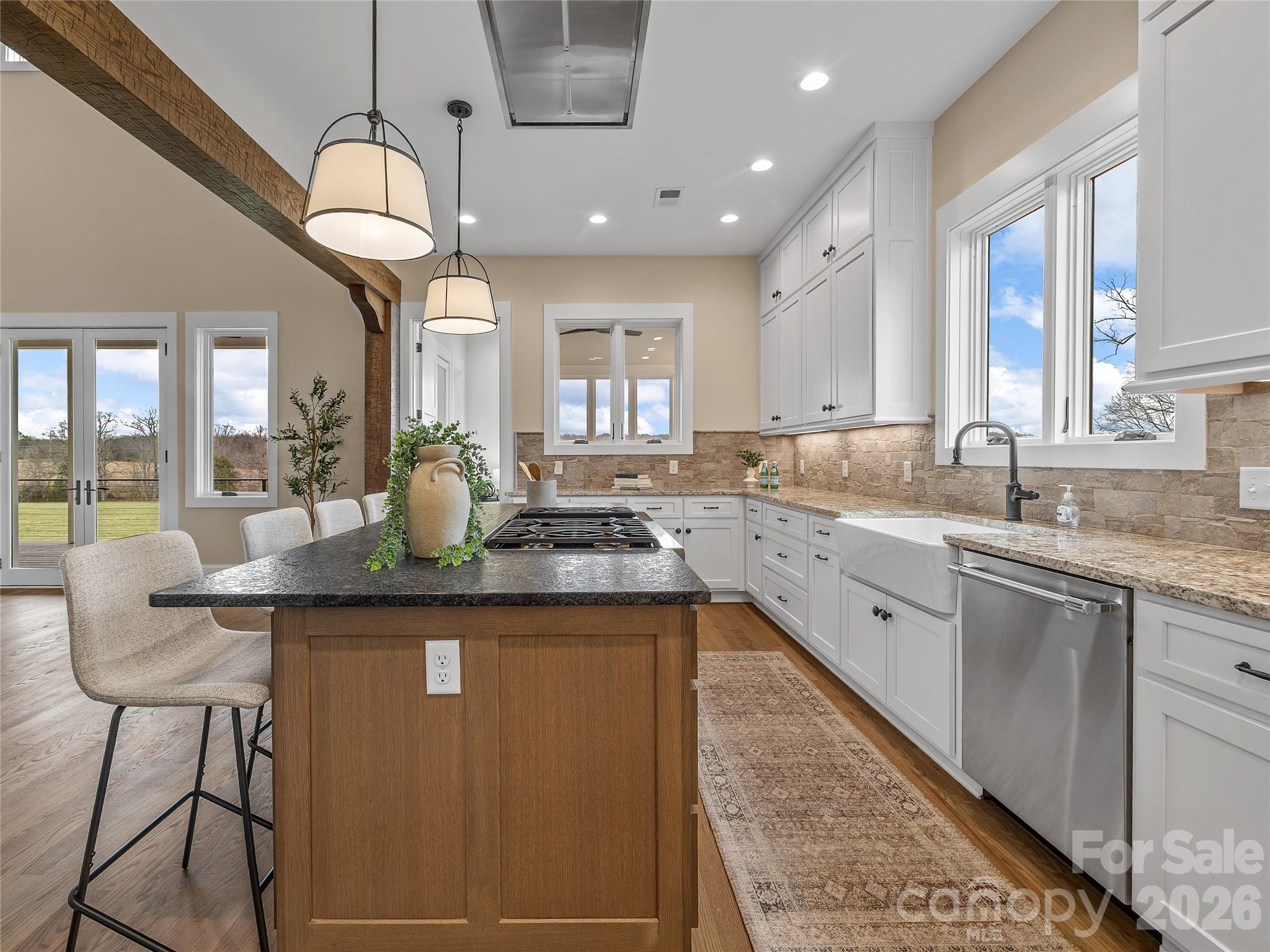 297 Mountain Meadows Lane, Unit 7 Tryon, NC 28782 - Photo 13 of 47 a kitchen with center island table and chairs